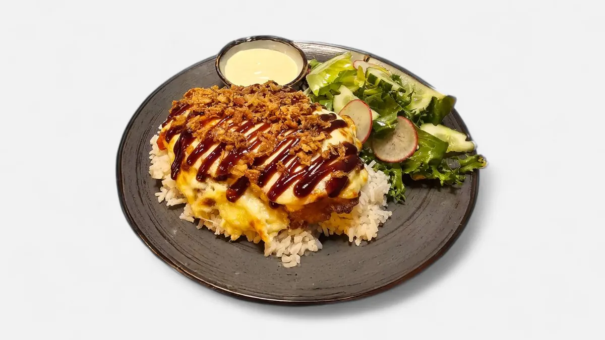 Ogle pork chop under a baked cheese crust with salad and potatoes